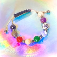 a bracelet with different colored stones on it
