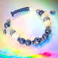 a black and white beaded bracelet on a colorful background