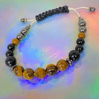 a bracelet with tiger eye beads and black beads