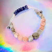 a bracelet with pink, blue, and grey stones